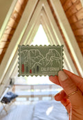 A vinyl sticker with an illustration of Yosemite National Park, California, held against a light background.