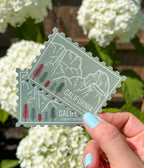 A vinyl sticker with an illustration of Yosemite National Park, California, held against a light background.