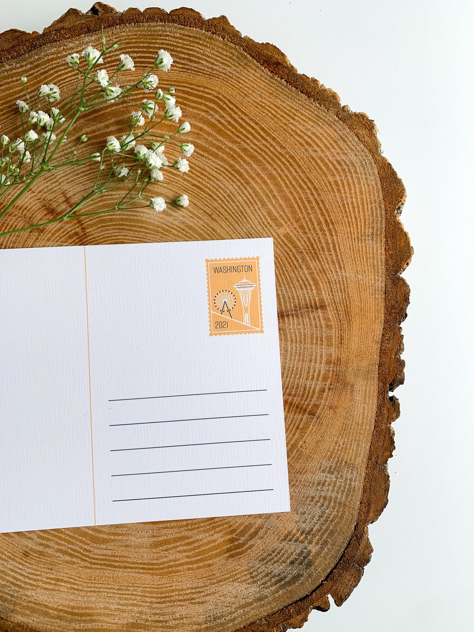 Illustrated washington state postcard on a wooden slab