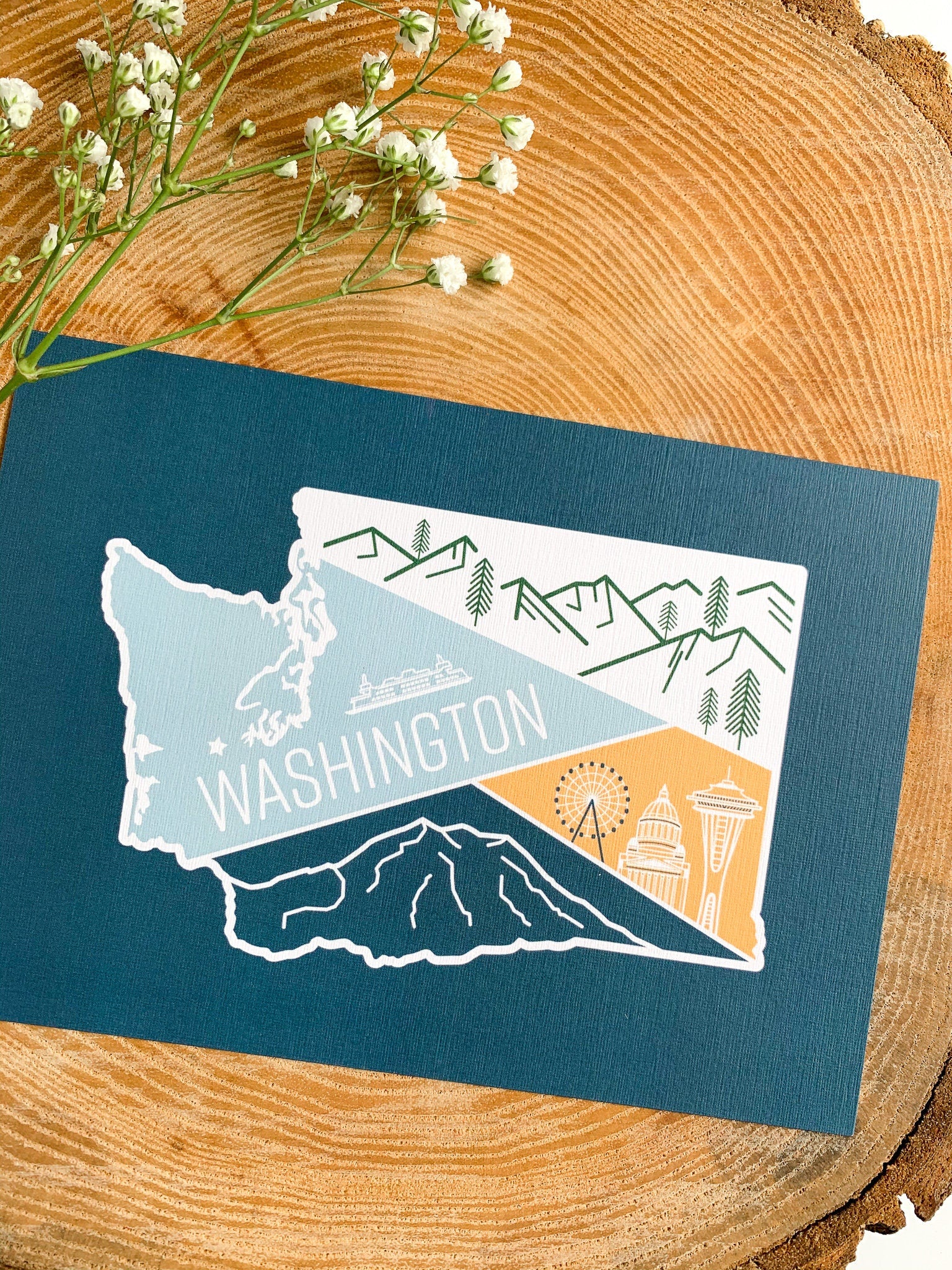 Illustrated washington state postcard on a wooden slab