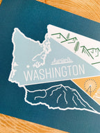 Illustrated washington state postcard on a wooden slab