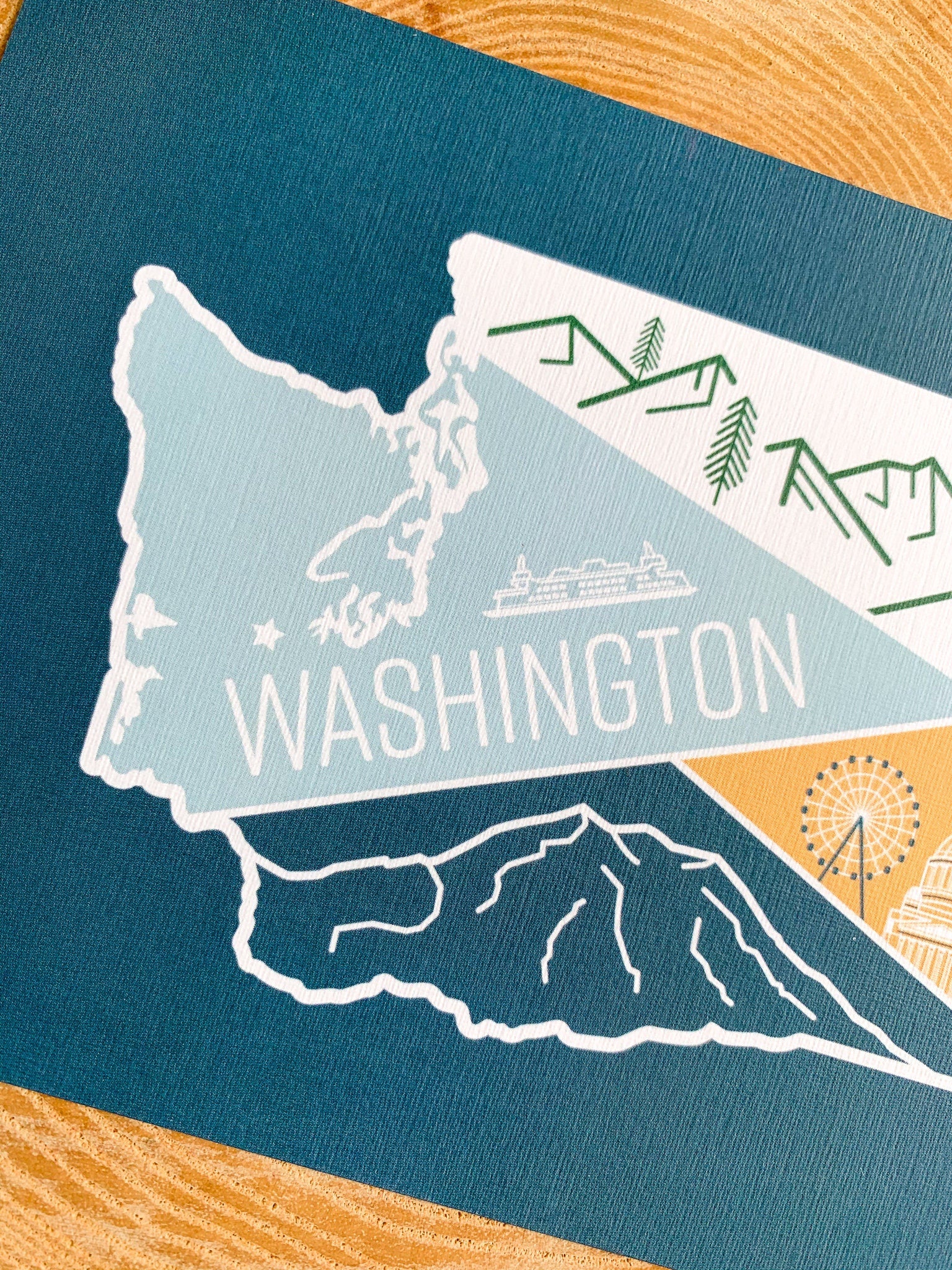 Illustrated washington state postcard on a wooden slab