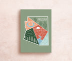 A postcard with an illustration representing Arizona's landscape, including a cactus and mountains, with a space for personalized messaging on the back.