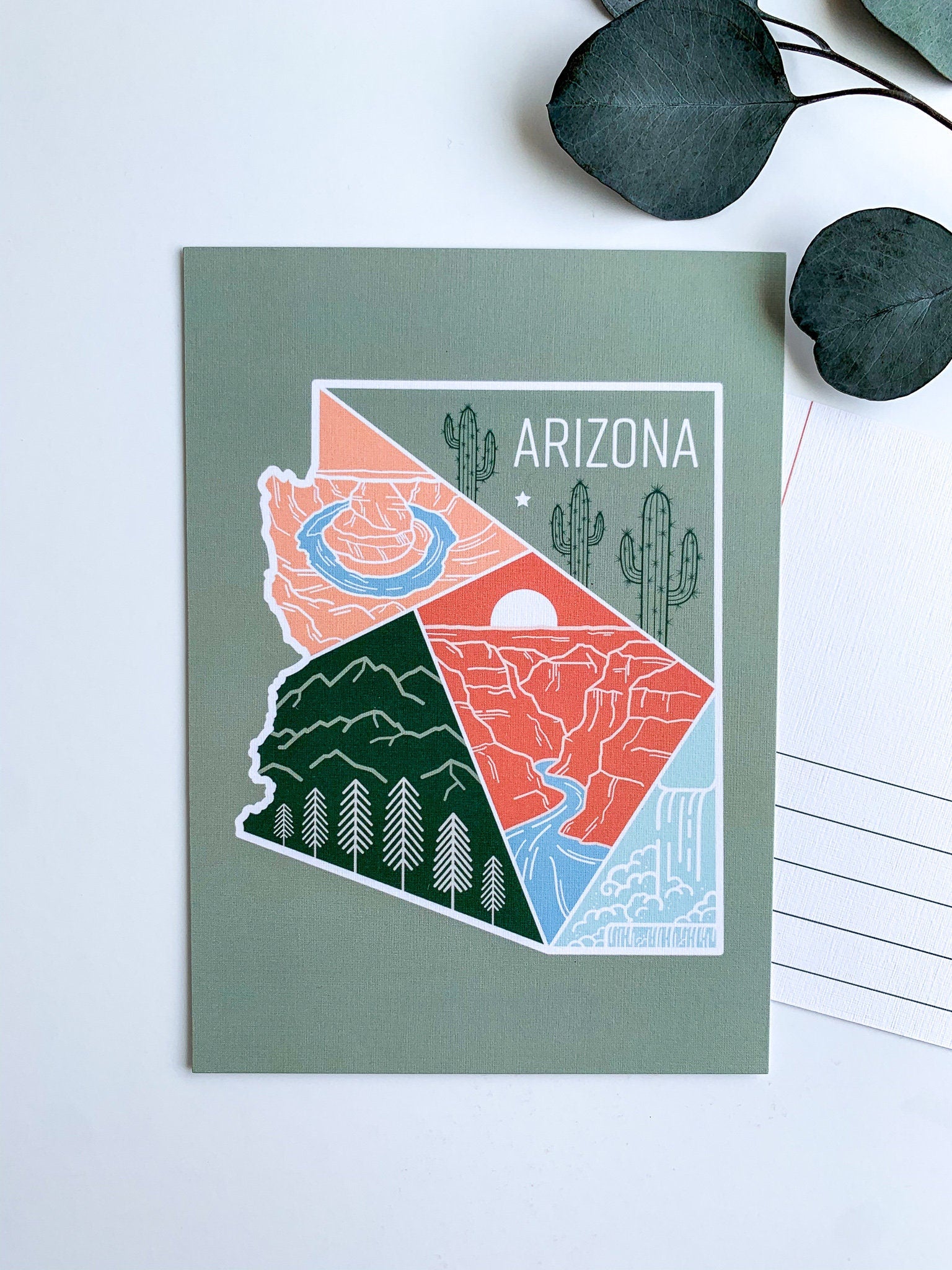 A postcard with an illustration representing Arizona's landscape, including a cactus and mountains, with a space for personalized messaging on the back.
