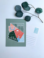 A postcard with an illustration representing Arizona's landscape, including a cactus and mountains, with a space for personalized messaging on the back.