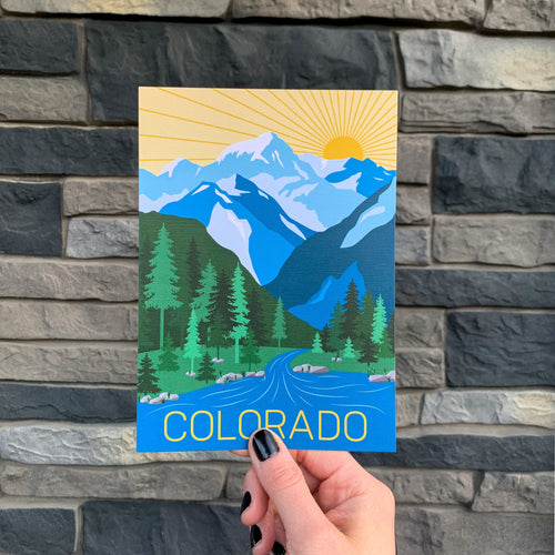 A postcard featuring an illustrated mountain range with the text 'COLORADO' at the bottom.