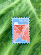 A magnet shaped like a postage stamp with an illustration of the Grand Canyon National Park, Arizona, die-cut to the shape of the stamp.